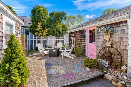 a backyard with a pink door and a table and chairs at 227 Winter St, Hyannis in Barnstable