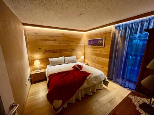 a bedroom with a bed with a red dress on it at maison la chapelle in Aosta