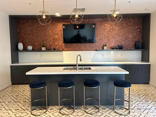 a kitchen with a sink and a tv on the wall at LUXURY APARTMENT IN HOLLYWOOD in Los Angeles