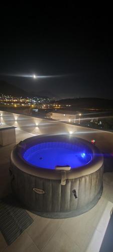 a hot tub on top of a building at night at Deluxe Apartmani Vila Pejovic Sutomore in Sutomore