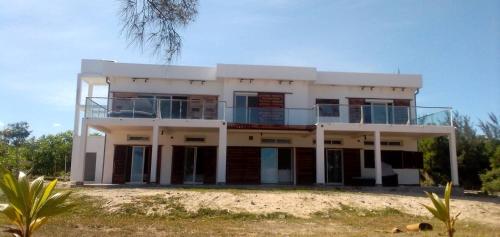 a large white house on top of a beach at Villa de luxe Domaine Léna vue sur mer in Foulpointe