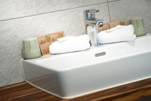 a bathroom sink with two folded towels on it at Canisiusbrünnl Self- Check in in Innsbruck