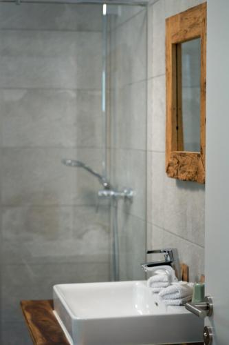 a bathroom with a white sink and a shower at Canisiusbrünnl Self- Check in in Innsbruck