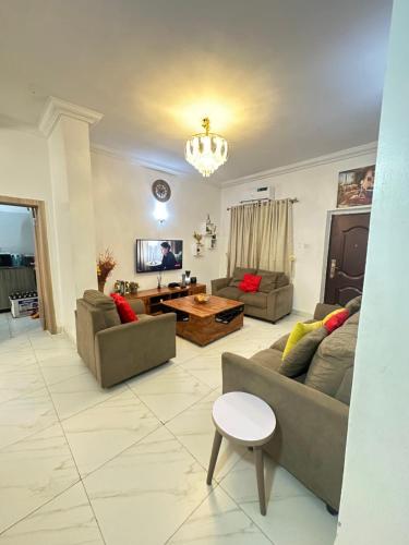 a living room with two couches and a table at Exotic 2 BR Apartment at Wuye, Abuja - Wifi,Netflix in Abuja