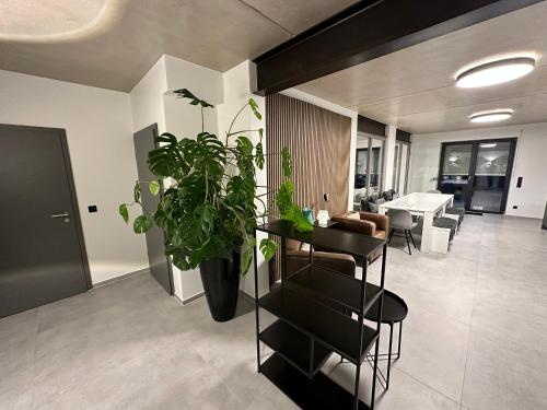 a living room with a table and a plant at Luxuriöses Apartment direkt am Kanal 125 m² - youpartments in Münster