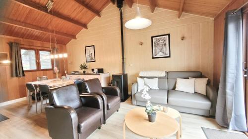 a living room with a couch and a table at Chalet La Boverie 195 in Rendeux