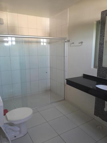 a bathroom with a shower and a toilet and a sink at Casalagoana in Marechal Deodoro