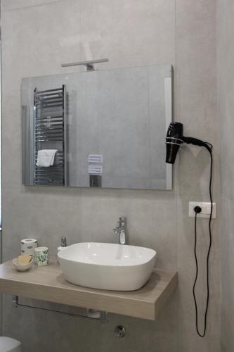 a bathroom with a sink and a mirror at Royal Dreams in Caserta