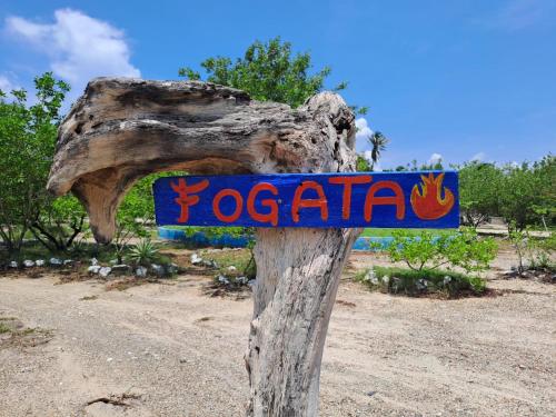 a sign on a wooden pole in the desert at Galerazambahostal in Galerazamba