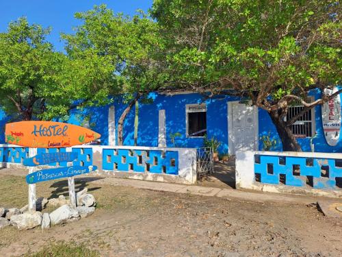 a blue building with an orange umbrella in front of it at Galerazambahostal in Galerazamba