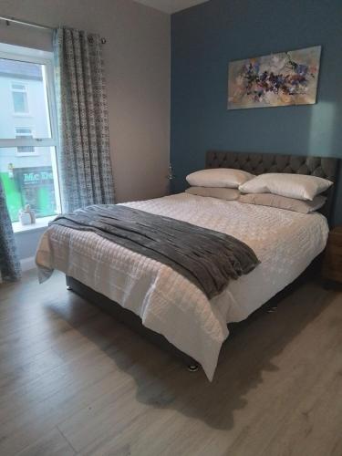 a large bed in a bedroom with a window at John & Mary's in Dromore