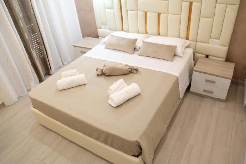 a bedroom with a large bed with towels on it at Royal Dreams in Caserta