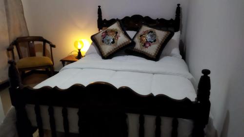 - un lit noir et blanc avec des oreillers dans l'établissement Casa Vacacional cerca al Parque del Café, à Montenegro
