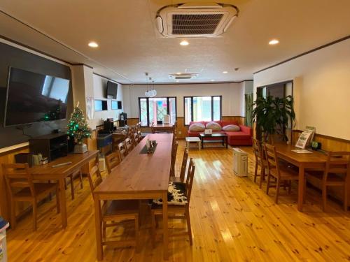 a room with tables and chairs and a living room at Guesthouse Danran - Vacation STAY 86826v in Beppu