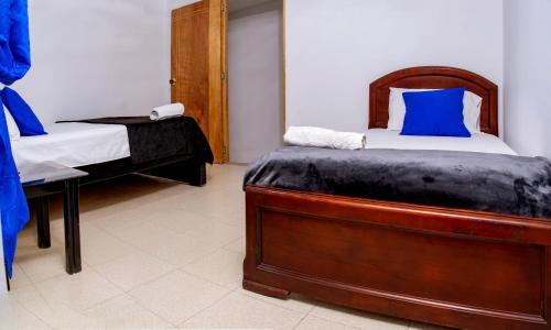 a bedroom with a bed and a desk with a phone at Secretos del Eden in Ruiosucio