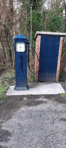 a blue gas pump next to a blue door at Holllie View in Enniskillen