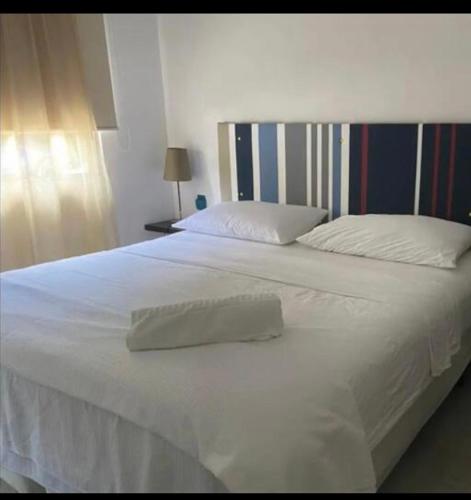 a large white bed with two pillows on it at Private Room Puerto Morelos in Puerto Morelos