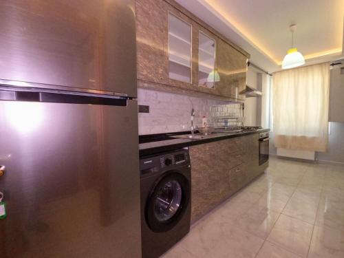 a kitchen with a washer and a washing machine at Big Historia Apartment in Istanbul