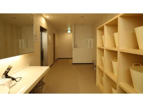 a room with a bathroom with a sink and shelves at Green Rich Hotel Naha - Vacation STAY 59243v in Naha