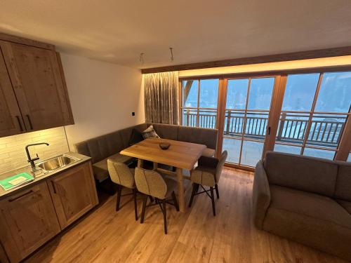 a kitchen and living room with a table and a couch at Samnaun, ChaletdMot in Samnaun