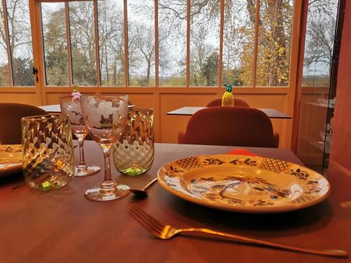 - une table avec une assiette et des verres dans l'établissement Domaine de Penthièvre, à Blangy-sur-Bresle