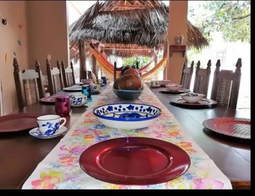 a table with a red plate on a colorful table cloth at casa lumka hotel boutique spa in Mariquita