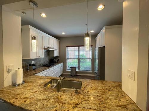 a kitchen with a sink and a counter top at Beautiful & Luxurious 2 bed 2 & half bth & 2 car attached garage TownHouse in Falls Church in Falls Church