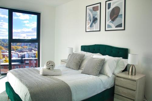 a bedroom with a large bed with a teddy bear on it at AP- Luxury Apt nxt to o2 Academy in Birmingham