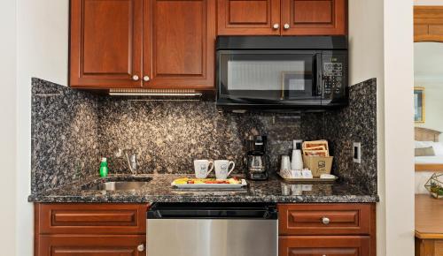 a kitchen with a sink and a microwave at La Mer Beachfront Resort in Cape May