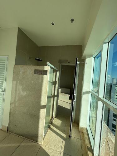 an elevator in a building with a glass door at SM504 Apart Hotel próximo a Esplanada in Brasilia