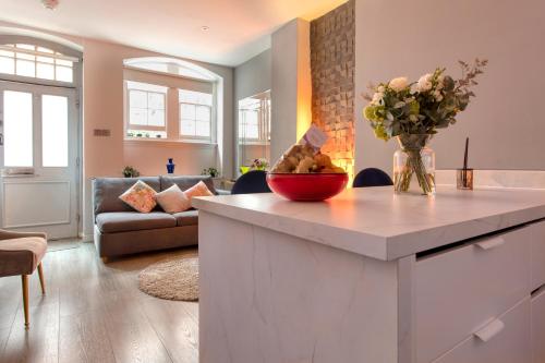 a kitchen with a counter with a vase of flowers at THE PAD at Sloane Square in London