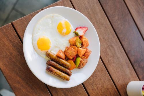 a plate of breakfast food with eggs and potatoes at Hotel MDR Marina del Rey- a DoubleTree by Hilton in Los Angeles