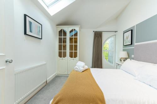 a bedroom with a bed and a window at Abbey Rd - St John's Wood Retreat by Aureva in London