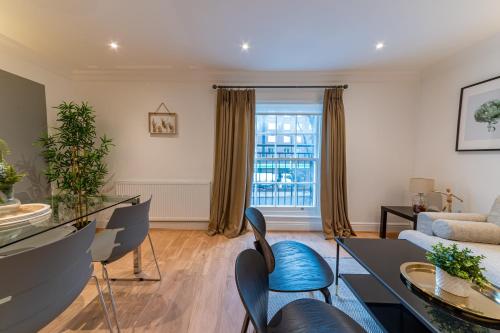 a living room with a table and chairs at Abbey Rd - St John's Wood Retreat by Aureva in London
