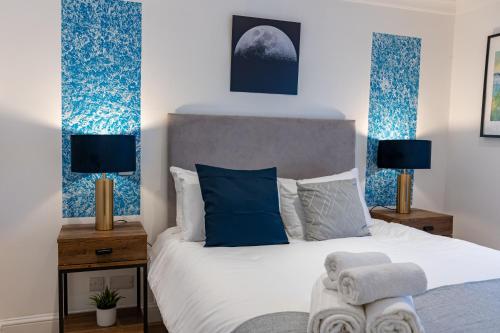 a bedroom with a bed with blue and white at Stylish LUXE 4Beds Abbey Rd St Johns Wood in London