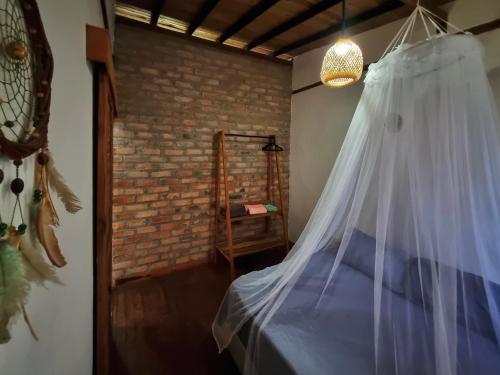 a bedroom with a bed with a mosquito net at La Floristería in Palomino