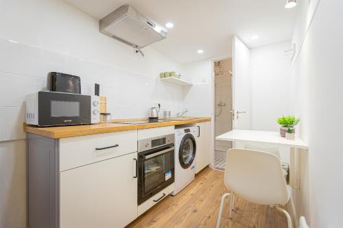 eine kleine Küche mit einer Spüle und einer Mikrowelle in der Unterkunft 2 bedroom apartment in the Dob street, Emerald in Budapest