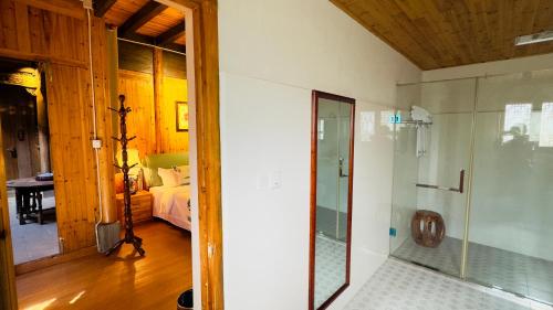 a bathroom with a shower and a bedroom at New Fragrant Hui Villa in Yi