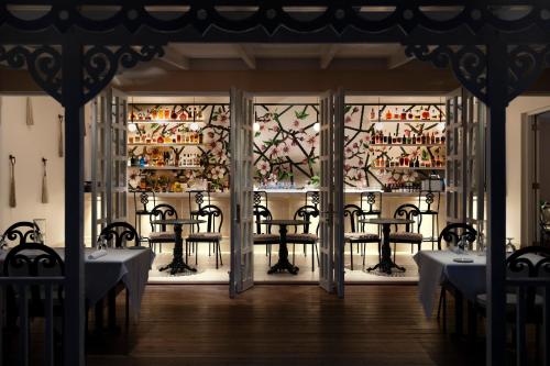 a restaurant with tables and chairs in front of a window at Point Grace in Grace Bay