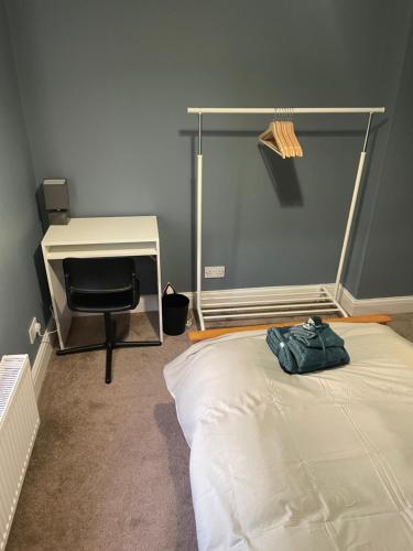 a bedroom with a bed and a desk and a chair at Single Room in Potters Bar Hertfordshire in Potters Bar