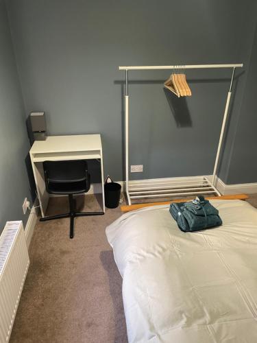 a bedroom with a bed and a desk and a chair at Single Room in Potters Bar Hertfordshire in Potters Bar