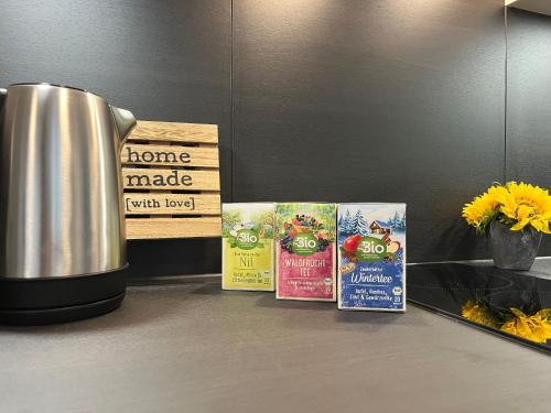 a counter with some signs and a pot of food at Modernes 2-Zimmer Themen-Apartment im Zentrum in Bayreuth