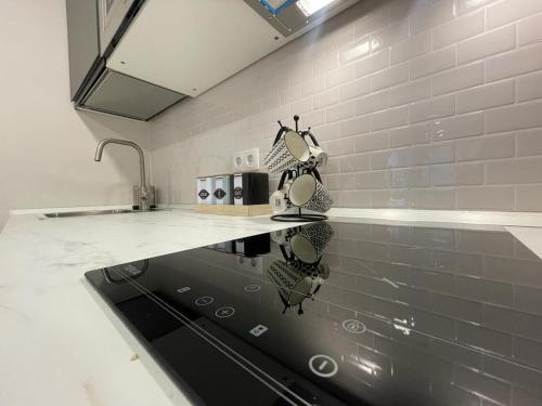 a kitchen with a sink and a stove at Alma in Madrid