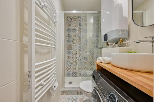 a white bathroom with a sink and a toilet at Joli Paris-Hyper centre in Paris