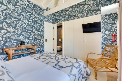 a bedroom with blue and white wallpaper and a bed at LÓIOS 74 by DA'HOME in Porto