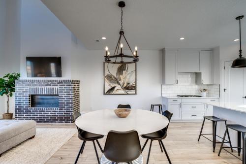 a kitchen and living room with a white table and chairs at Modern Downtown Provo Townhome with Balcony! in Provo