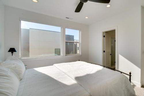 a bedroom with a large white bed with a window at Modern Downtown Provo Townhome with Balcony! in Provo