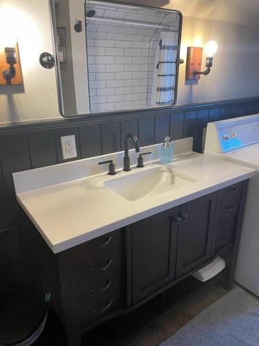 a bathroom with a sink and a mirror at Spearfish Cottages in Spearfish