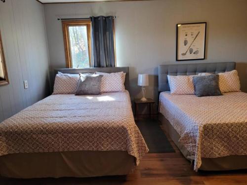 a bedroom with two beds and a window at Entire 3 Bedroom Home in Rumbling Bald Resort in Lake Lure