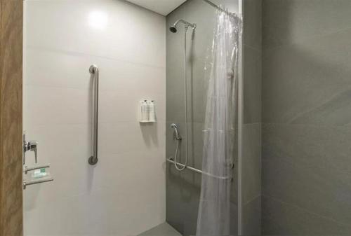 a shower with a glass door in a bathroom at Laghetto Resort Golden Gramado in Gramado